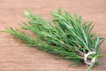 Bunch of rosemary on a rustic wood