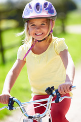 Young Girl Riding Bike Along Country Track