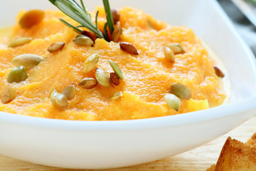 fresh pumpkin soup in a white bowl