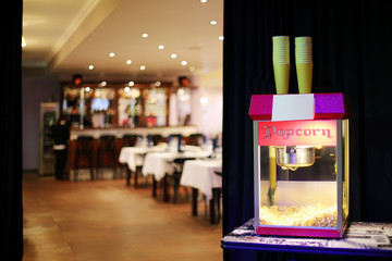 Popcorn machine in background of restaurant and bar