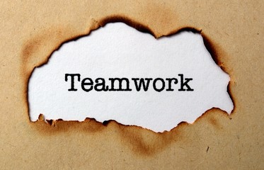 Teamwork text on paper hole