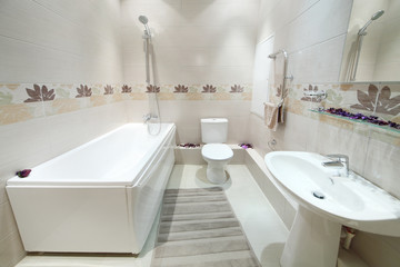 Clean and new bathroom with toilet with tiles on walls