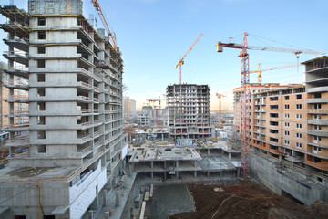 Multi-storey buildings under construction and cranes