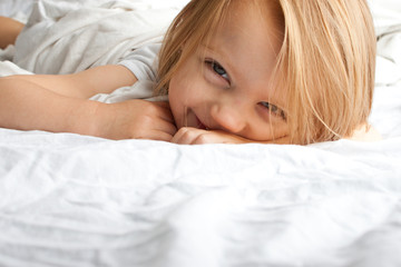 Beautiful little girl smiling after waking up