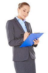Businesswoman writing notes on a clipboard