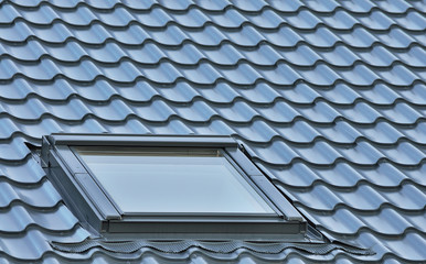 Roof window on a grey tiled rooftop large detailed loft skylight