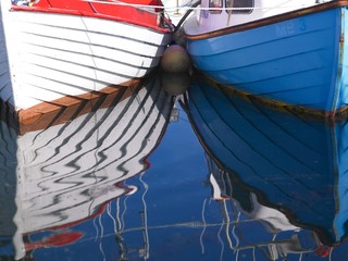 reflection of boats in water