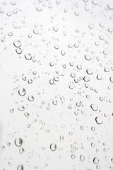 Fototapeta na wymiar Drops of rain on the inclined window