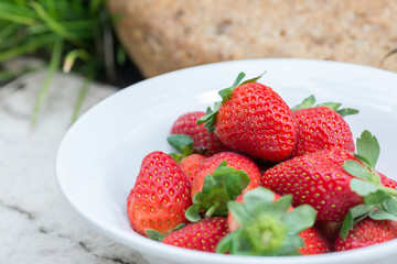 Strawberries in a bowl in the garden