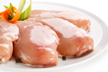 Raw chicken breasts on white background