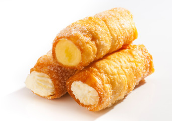 combs and honey pastry filled with cream, on white background