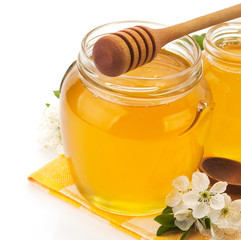 glass jar full of honey and stick