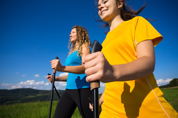 Nordic walking - active people outdoor (focus on hand)