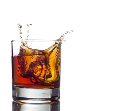 Glass of whiskey solated on white background