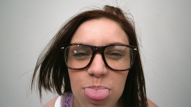 Cheerful young woman looking at camera with tongue out