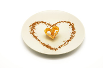 piece of fried flower decorated with heart-shaped cinnamon