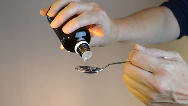 drop medicine on spoon female w sleeve