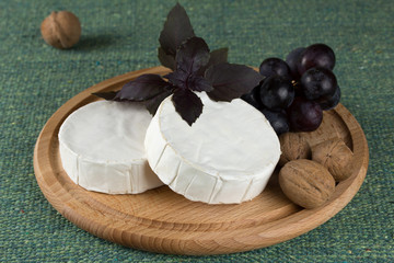 cheese platter with  nuts and  grapes