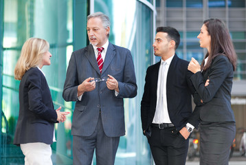 Group of business people stood outside building