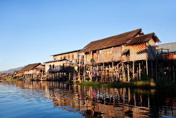 Fototapeta na wymiar Village of Intha people over water on Inle lake, Myanmar