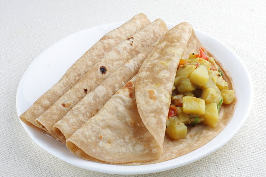 Vegetarian sandwich, chapati with cooked vegetables.