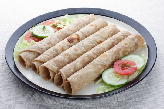 Indian flat-bread called chapati rollswith vegetable .