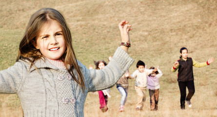 Happy children running on meadow