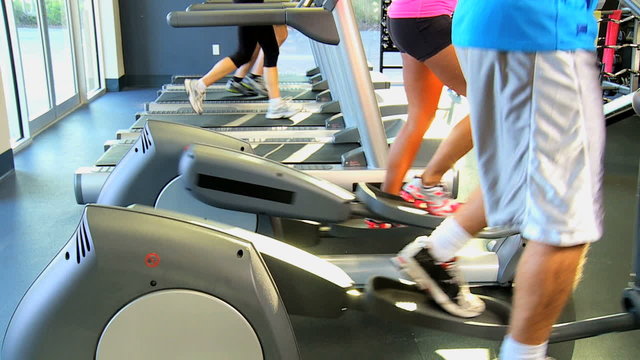 People Exercising Health Club Equipment Legs Only 