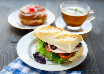 Breakfast with sandwich, tea and cake