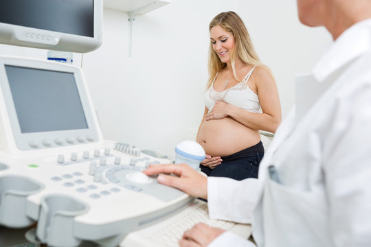 Pregnant Woman With Obstetrician In Clinic