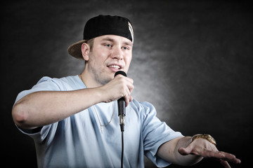 Rap singer man with microphone cool hand gesture