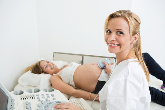 Doctor Examining Pregnant Belly By Ultrasonic Scan
