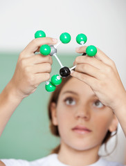 Teenage Schoolgirl Examining Molecular Structure