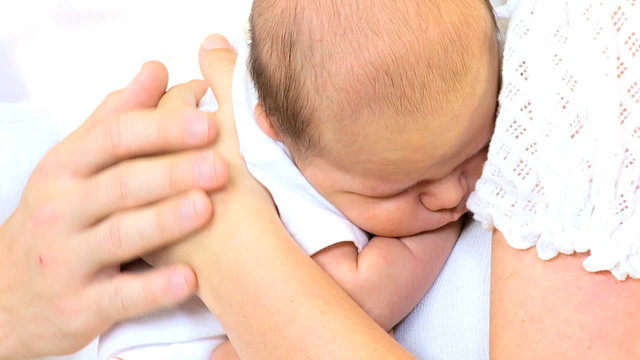 Sleeping Baby Boy Cradled Young Caucasian Parents