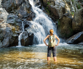 Female hiker looking at waterfall