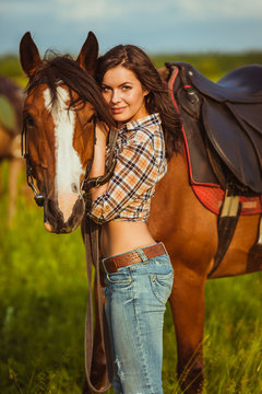 beautiful woman standing near a horse