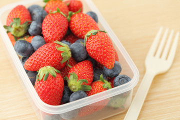Strawberry and blueberry mix in plastic box