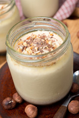 chocolate and coffee yogurt with nuts in portions, close-up