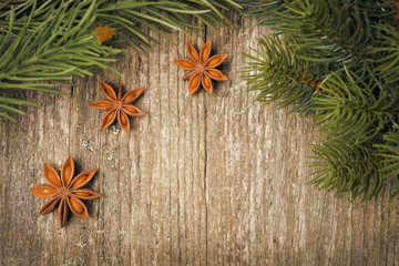 Obraz na płótnie Canvas Christmas frame (spruce branches and star anise) on the old wood