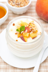 homemade yogurt with honey, peaches and nuts, top view