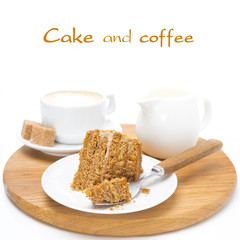 piece of honey cake on a plate, cream and cup of cappuccino