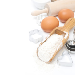 scoop with wheat flour, rolling pin, eggs, cookie cutters