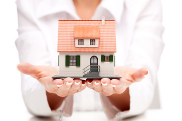 Small toy house in hands