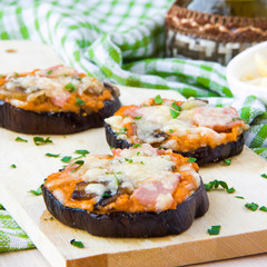 Slice of fried aubergines with tomato sauce, mushrooms, ham and
