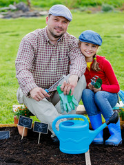 Gardening, girl helping father in the garden