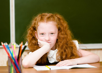 Portrait of lovely schoolgirl looking at camera