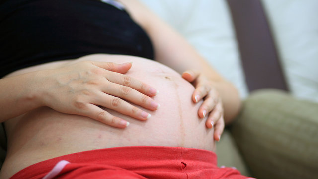 Pregnant woman hold her belly