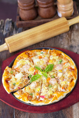 Fresh pizza on a wooden board