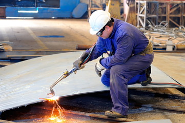 a welder working at shipyard in day time