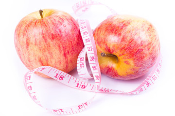 Apple and measuring tape isolated on white background.